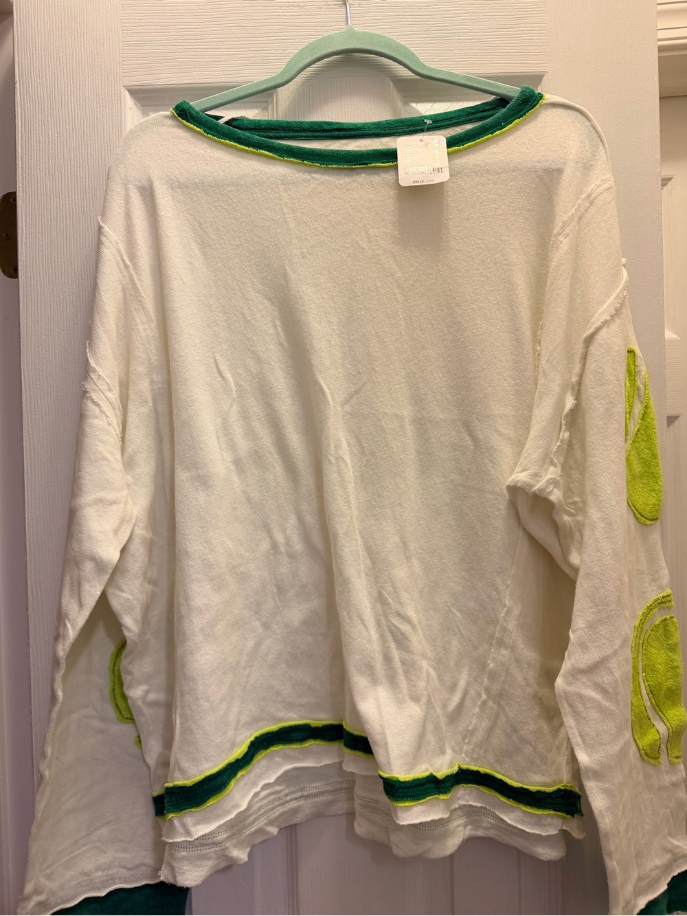 We The Free Cream Long Sleeve Tee tennis balls on sleeves